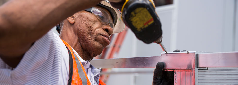 deskless worker drilling on job site